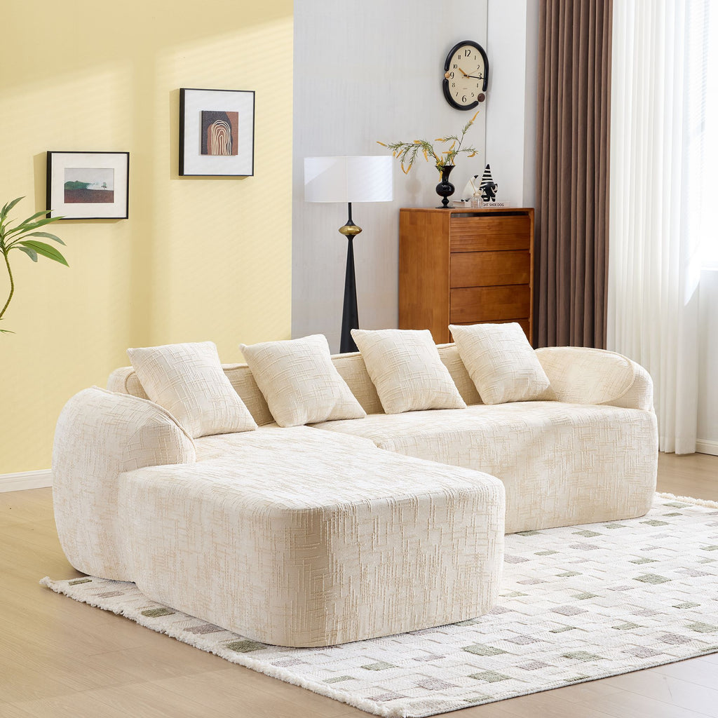 Beige L-Shaped Sofa with Curved Armrests and Throw Pillows