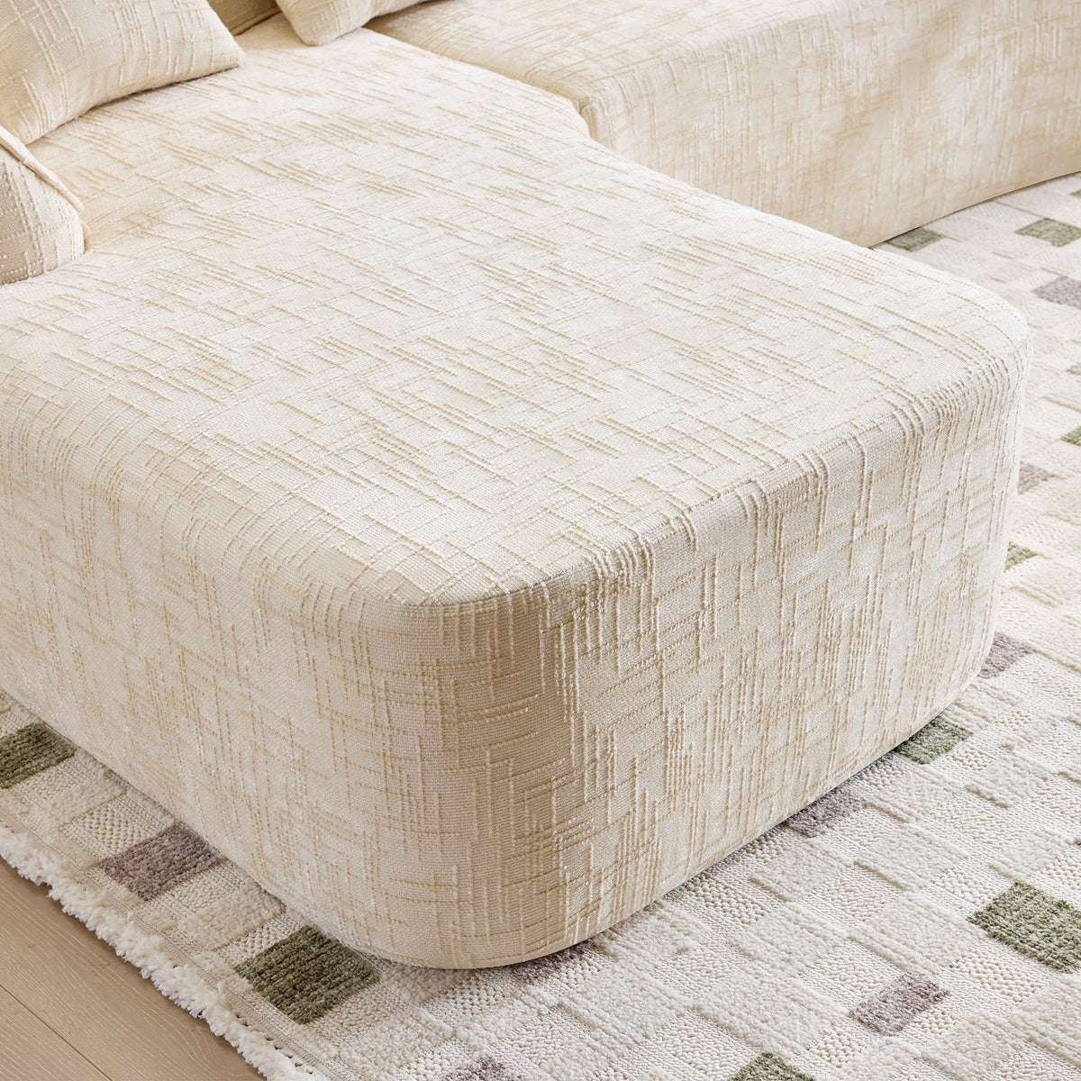 Beige L-Shaped Sofa with Curved Armrests and Throw Pillows