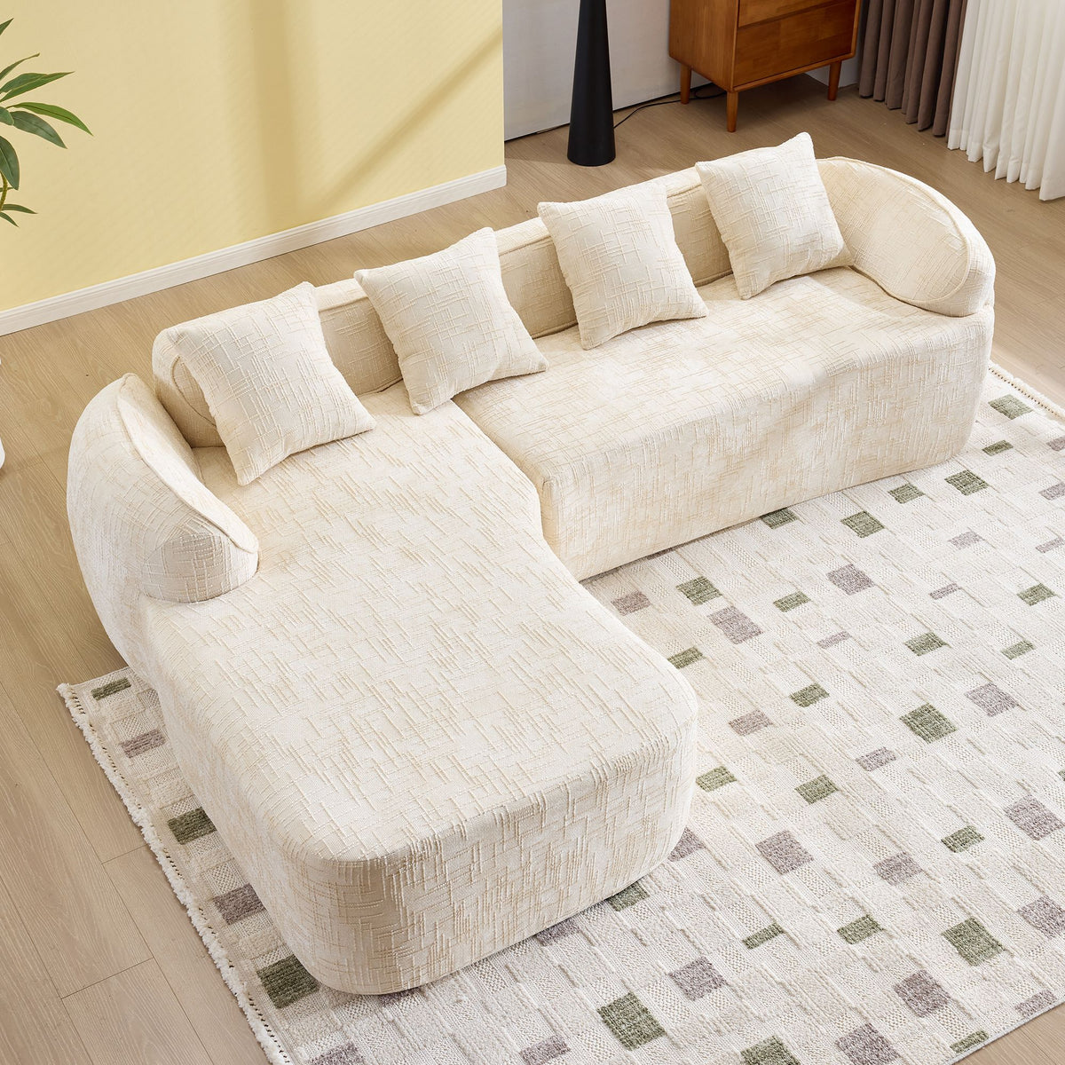 Beige L-Shaped Sofa with Curved Armrests and Throw Pillows