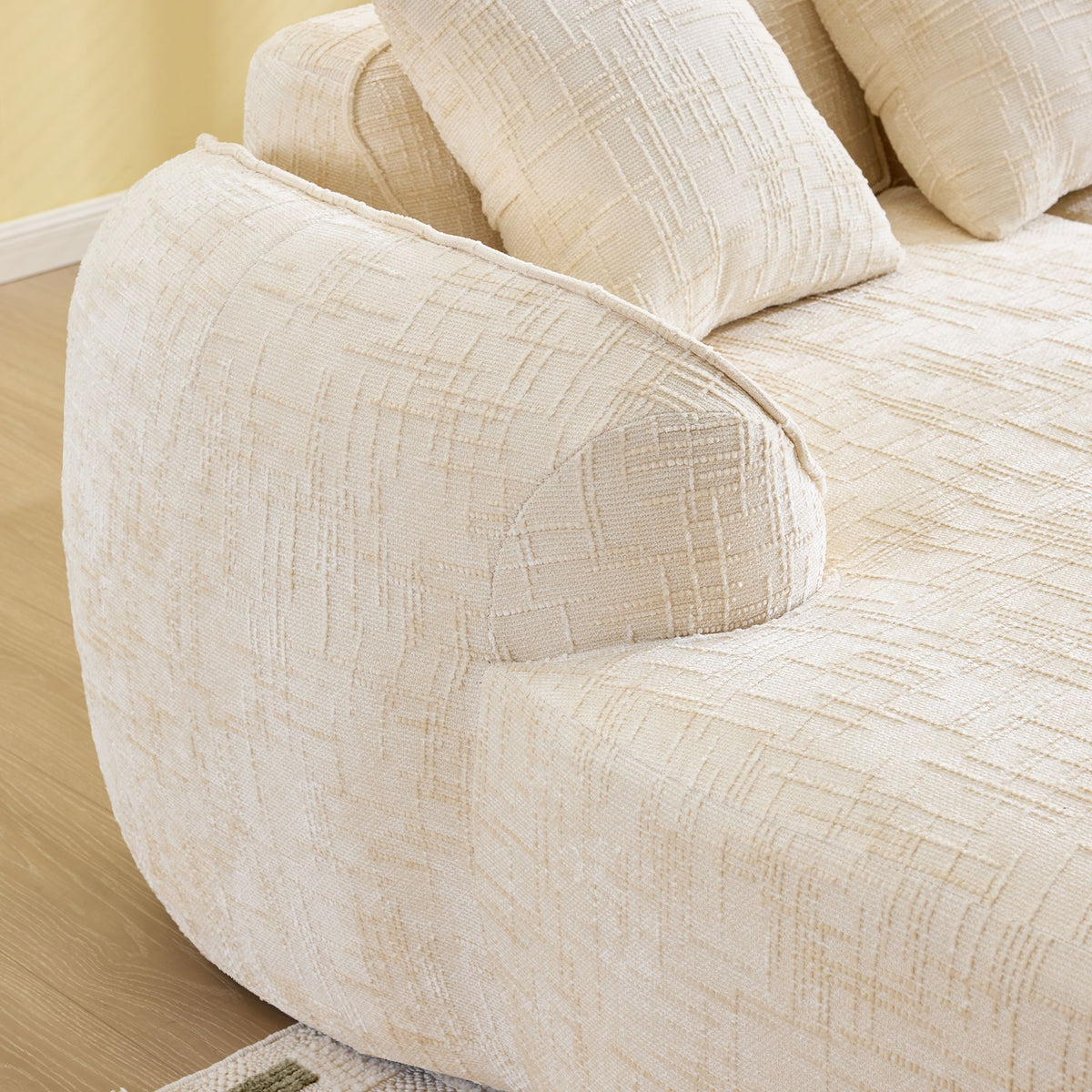 Beige L-Shaped Sofa with Curved Armrests and Throw Pillows