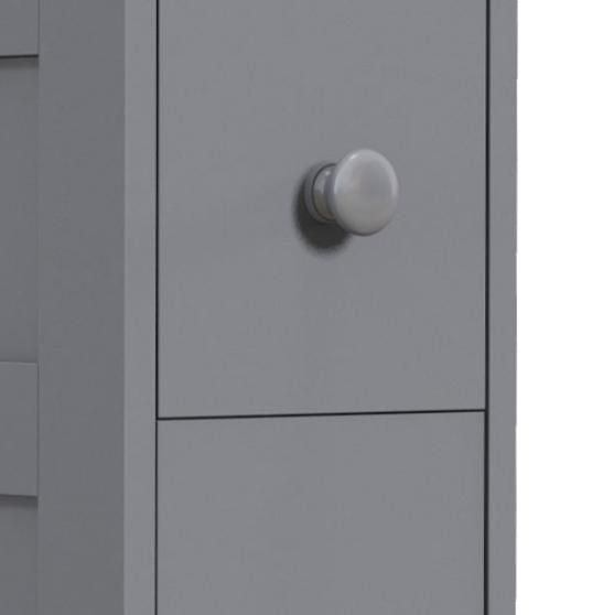 Gray space saving narrow bathroom storage cabinet with drawers and roller bathtub toilet