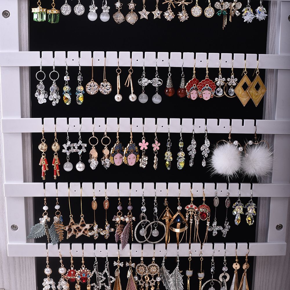 Wall-Mounted Mirrored Jewelry Cabinet With a Locking Door