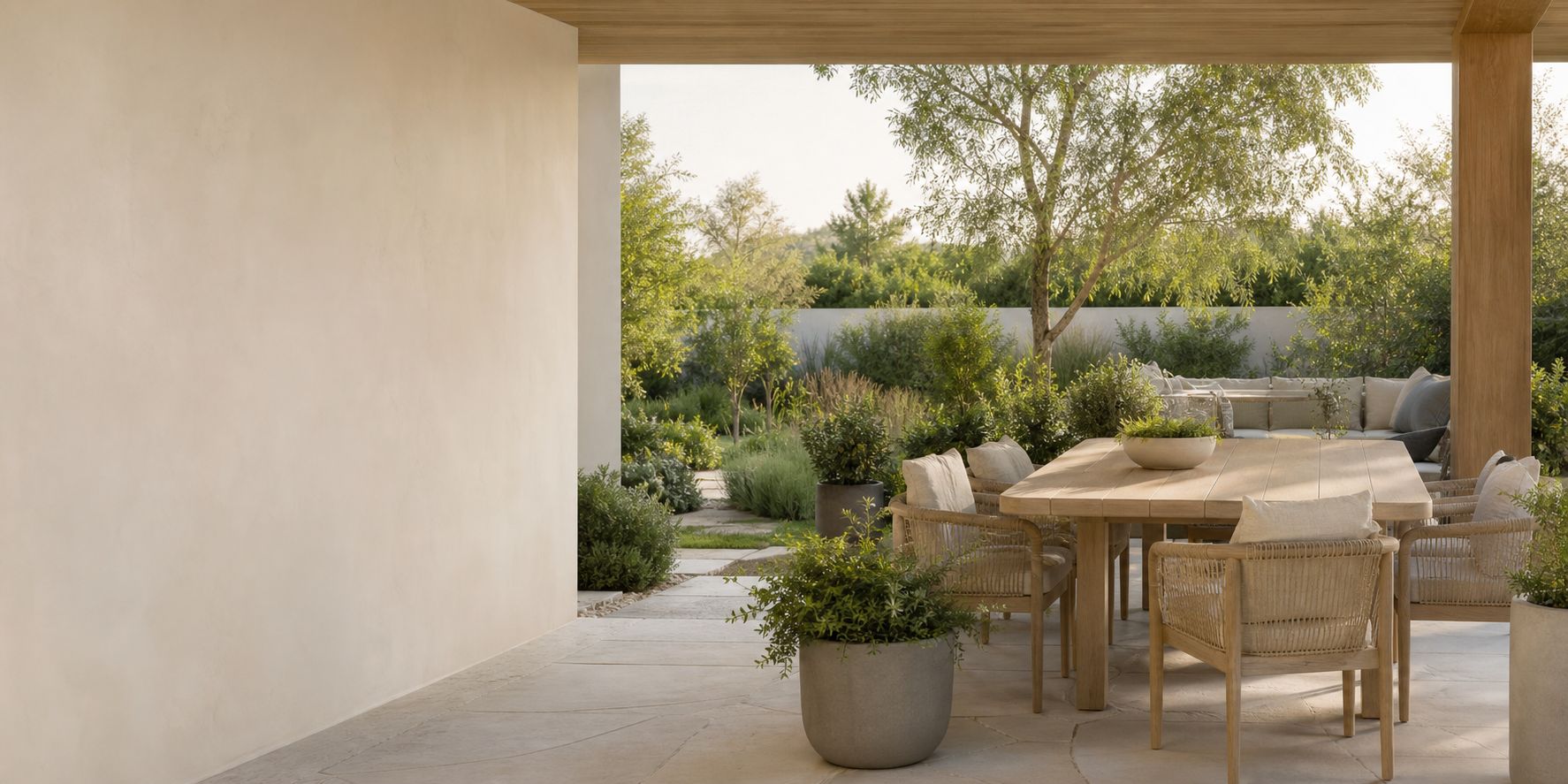 A covered patio dining area opening onto a planted garden